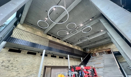 Fugearbejde i atrium med beton, glas og åbne flader i Sankt Annæ Musikhus